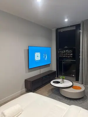a bedroom with a bed and a flat screen tv at 4413 At Ellipse Waterfall in Midrand