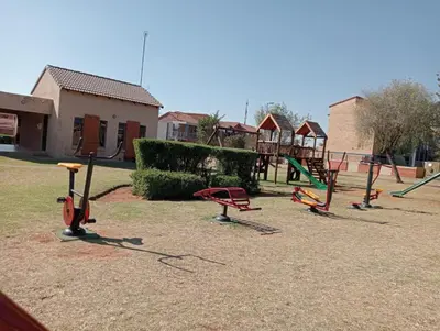 a group of playground equipment in a park at Fairway Gardens in Pretoria