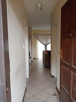 a hallway with a door leading to a living room at Fairway Gardens in Pretoria