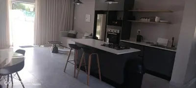 a kitchen with a counter and bar stools in it at Mupauli Boutique Lodge