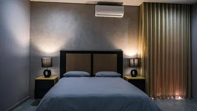 a bedroom with a large bed with two night stands at Mupauli Boutique Lodge