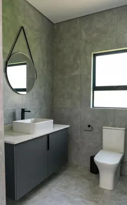 a bathroom with a sink and a toilet and a mirror at Mupauli Boutique Lodge
