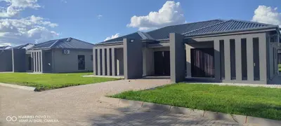 a row of houses with grass in front of them at Mupauli Boutique Lodge