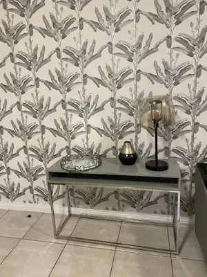a table in front of a wall with a wallpaper at Unit 438, The Blyde, Pretoria East in Pretoria