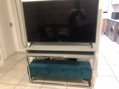 a flat screen tv sitting on a tv stand at Unit 438, The Blyde, Pretoria East in Pretoria