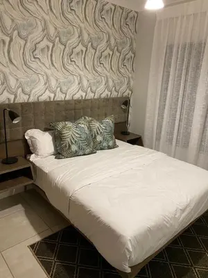 a bed with two pillows on it in a bedroom at Unit 438, The Blyde, Pretoria East in Pretoria