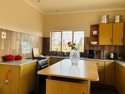 a kitchen with a vase of flowers on a table at Bird & Bed Farmhouse in Brits