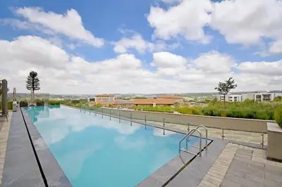 a swimming pool on the roof of a building at Stylish Penthouse Studio in Ellipse Waterfall in Midrand