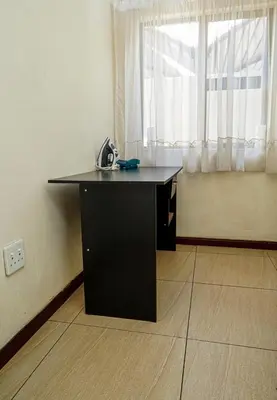 a black desk in a room with a window at Royal Palm in Mokopane