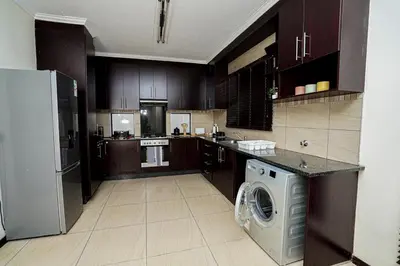 a kitchen with a washer and dryer in it at Royal Palm in Mokopane