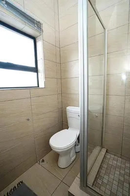 a bathroom with a toilet and a shower at Royal Palm in Mokopane