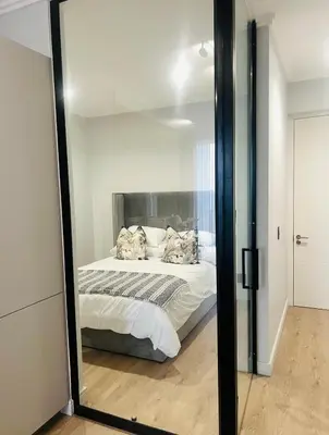 a bedroom with a bed and a mirror at Ellipse Waterfall 41110 in Midrand