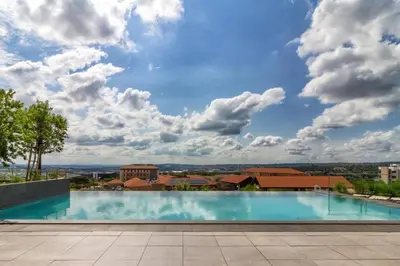 a large swimming pool on top of a building at Ellipse Waterfall 41110 in Midrand