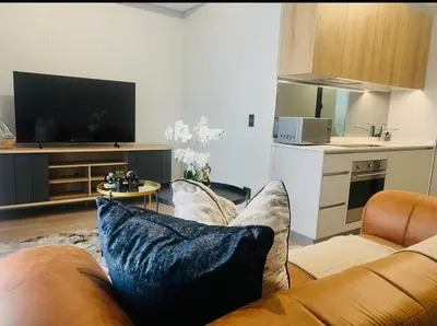 a living room with a couch and a tv at Ellipse Waterfall 41110 in Midrand