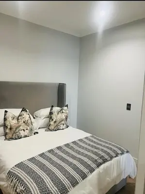 a bedroom with a bed with pillows on it at Ellipse Waterfall 41110 in Midrand