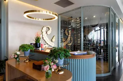 a store lobby with a counter with flowers on it at Ellipse Waterfall 41110 in Midrand