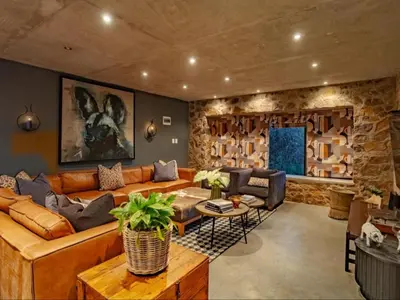 a living room with a couch and a table at Dombeya Private Game Reserve in Vaalwater