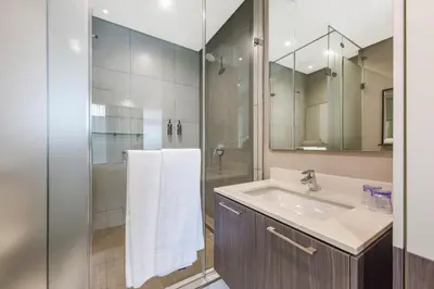 a bathroom with a sink and a shower at Menlyn Main Apartments Trilogy Collection in Pretoria