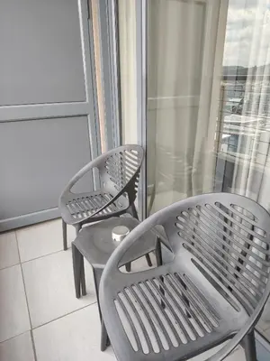 two chairs and a table on a balcony at Menlyn Maine Trilogy Apartment 1506 in Pretoria