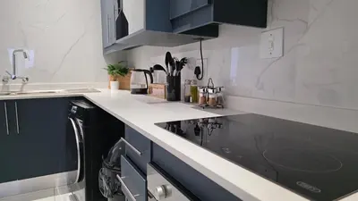 a kitchen with a black and white counter top at The village Executive Luxe Suites in Thohoyandou