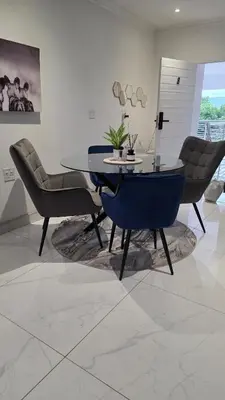 a dining room with a table and chairs at The village Executive Luxe Suites in Thohoyandou