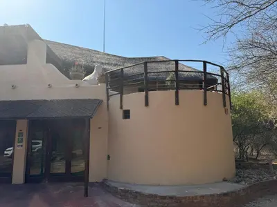 a building with a balcony on the side of it at Villa Leopards Lookout in Marloth Park
