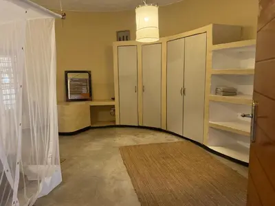 a living room with white cabinets and a rug at Villa Leopards Lookout in Marloth Park
