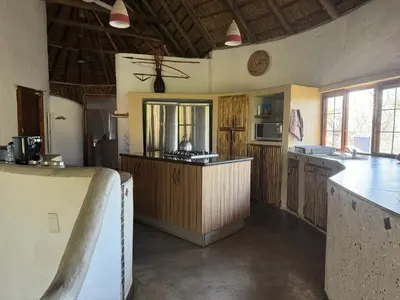 a large kitchen with a counter in a room at Villa Leopards Lookout in Marloth Park