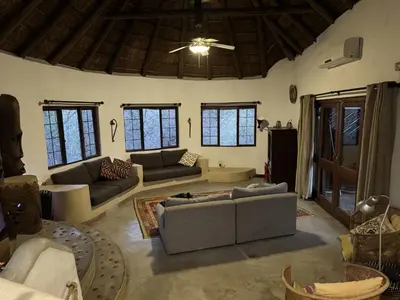 a living room with couches and a ceiling at Villa Leopards Lookout in Marloth Park