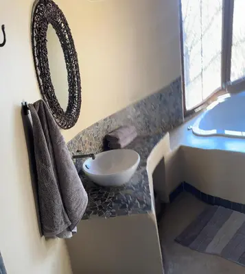 a bathroom with a sink and a bowl on a counter at Villa Leopards Lookout in Marloth Park