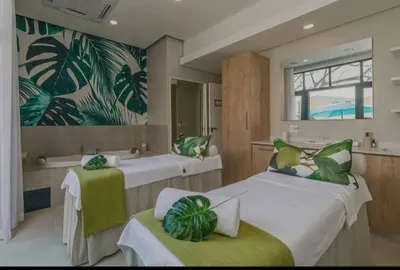 a room with two beds and a tub and a sink at Munyaka Luxe 4 mins away from Mall of Africa in Midrand