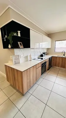 a large kitchen with a counter and a sink at Munyaka Luxe 4 mins away from Mall of Africa in Midrand