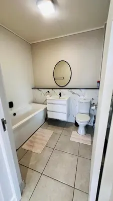 a bathroom with a toilet and a tub and a sink at Munyaka Luxe 4 mins away from Mall of Africa in Midrand