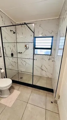 a bathroom with a shower and a toilet at Munyaka Luxe 4 mins away from Mall of Africa in Midrand