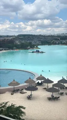 a group of umbrellas on a beach next to the water at Munyaka Luxe 4 mins away from Mall of Africa in Midrand