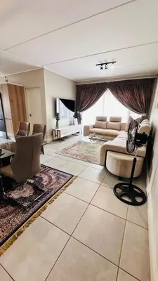 a large living room with a couch and a table at Munyaka Luxe 4 mins away from Mall of Africa in Midrand