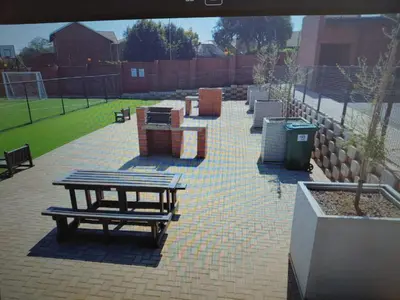 a picnic table and benches on a brick patio at LSG Delta in Centurion