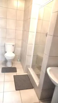 a bathroom with a shower and a toilet and a sink at LSG Delta in Centurion