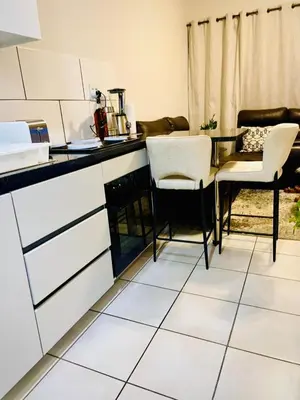 a kitchen with a table and chairs in a room at LSG Delta in Centurion