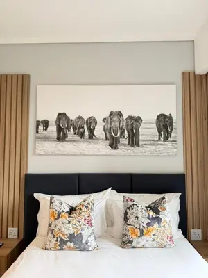 a black and white photo of a herd of elephants at Menlyn Maine Trilogy Apartments When Home is Far in Pretoria
