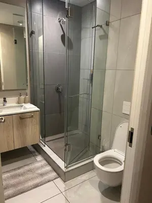 a bathroom with a shower and a toilet and a sink at Menlyn Maine Trilogy Apartments When Home is Far in Pretoria