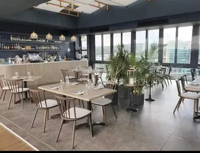 a restaurant with tables and chairs and a bar at Menlyn Maine Trilogy Apartments When Home is Far in Pretoria
