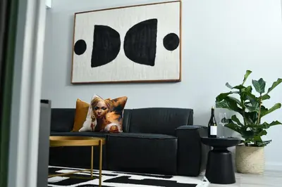 a living room with a couch and a picture on the wall at Apartment in Menlyn Maine, The Capital Trilogy in Pretoria