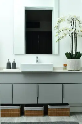 a bathroom with a white sink and a mirror at Apartment in Menlyn Maine, The Capital Trilogy in Pretoria