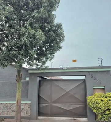 a garage door with a tree in front of a house at Nare Guesthouse in Soshanguve