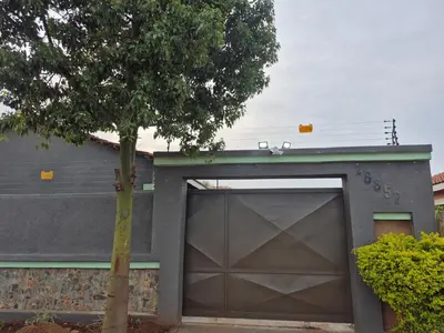a garage door with a tree in front of a house at Nare Guesthouse in Soshanguve
