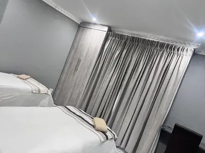 a bedroom with two beds and a curtain at MoyMoy Lifestyle Lodge in Meetse-a-Bophelo