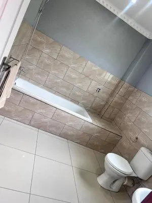 a bathroom with a toilet and a bath tub at MoyMoy Lifestyle Lodge in Meetse-a-Bophelo