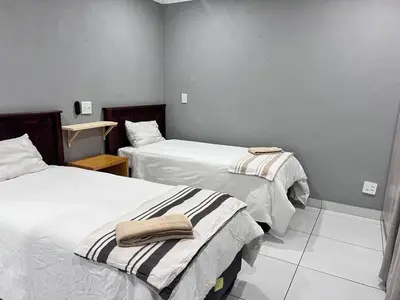 a room with two beds with towels on them at MoyMoy Lifestyle Lodge in Meetse-a-Bophelo