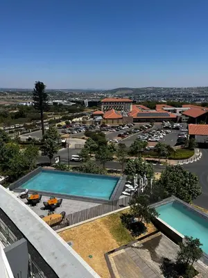 an aerial view of a resort with two swimming pools at Elegant Ellipse Waterfall Luxury with Gym, Spa & Dining in Midrand